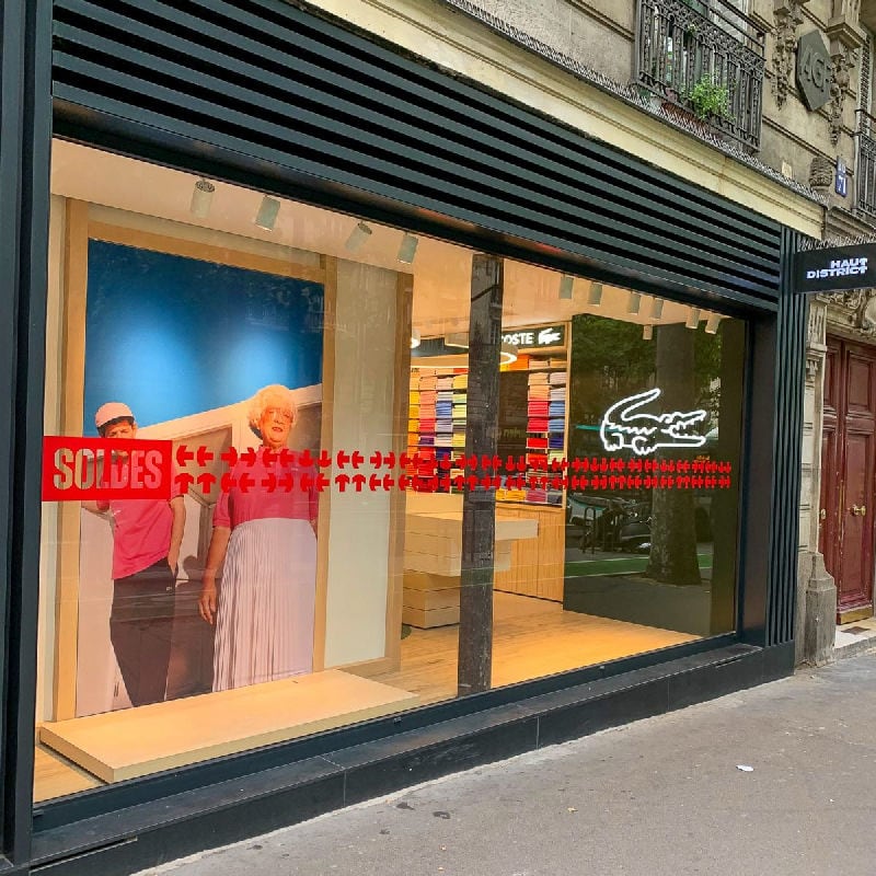 Lacoste window display adhesive application Paris